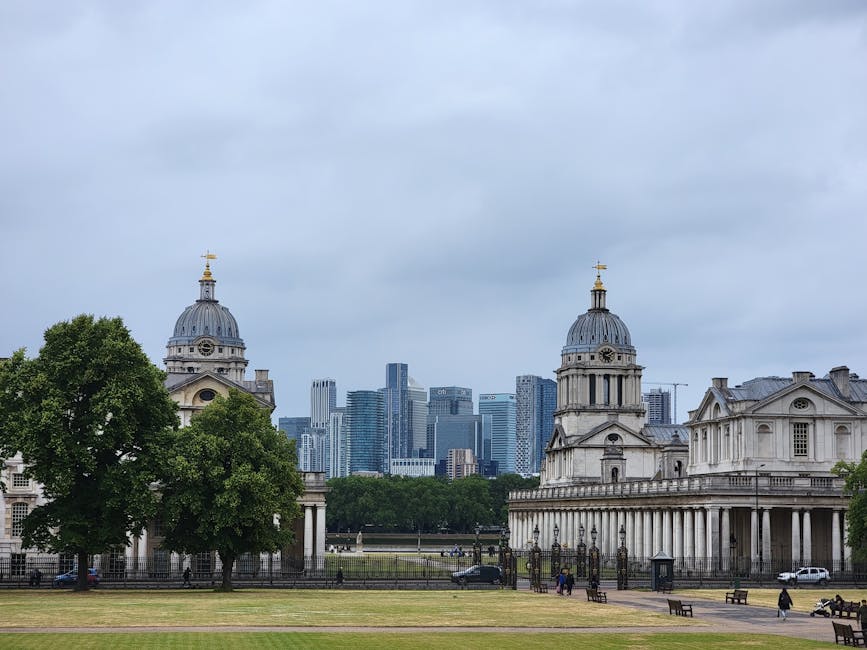 The image features a cityscape background with modern skyscrapers made of glass and steel, contrasted by historic classical buildings with columns and domed roofs in the foreground. The foreground als
